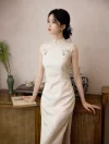 Model in a classic white qipao prom dress leaning against a vintage wooden cabinet, capturing a serene oriental style.