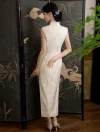 Elegant white qipao dress back view shown by a model standing in front of a traditional Chinese crane screen.