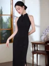 Graceful look of a woman in a modern black halter cheongsam with subtle floral textures, looking down with her hair styled in a classic bun.